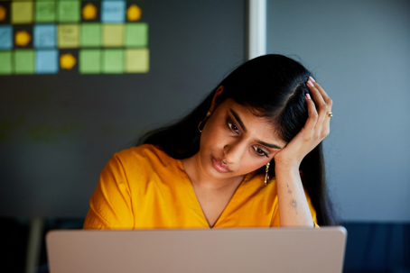 stressed person on a computer