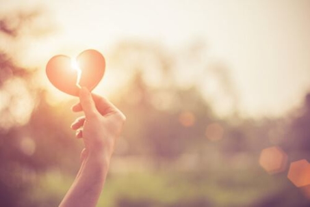 hand holding broken heart - silhouette