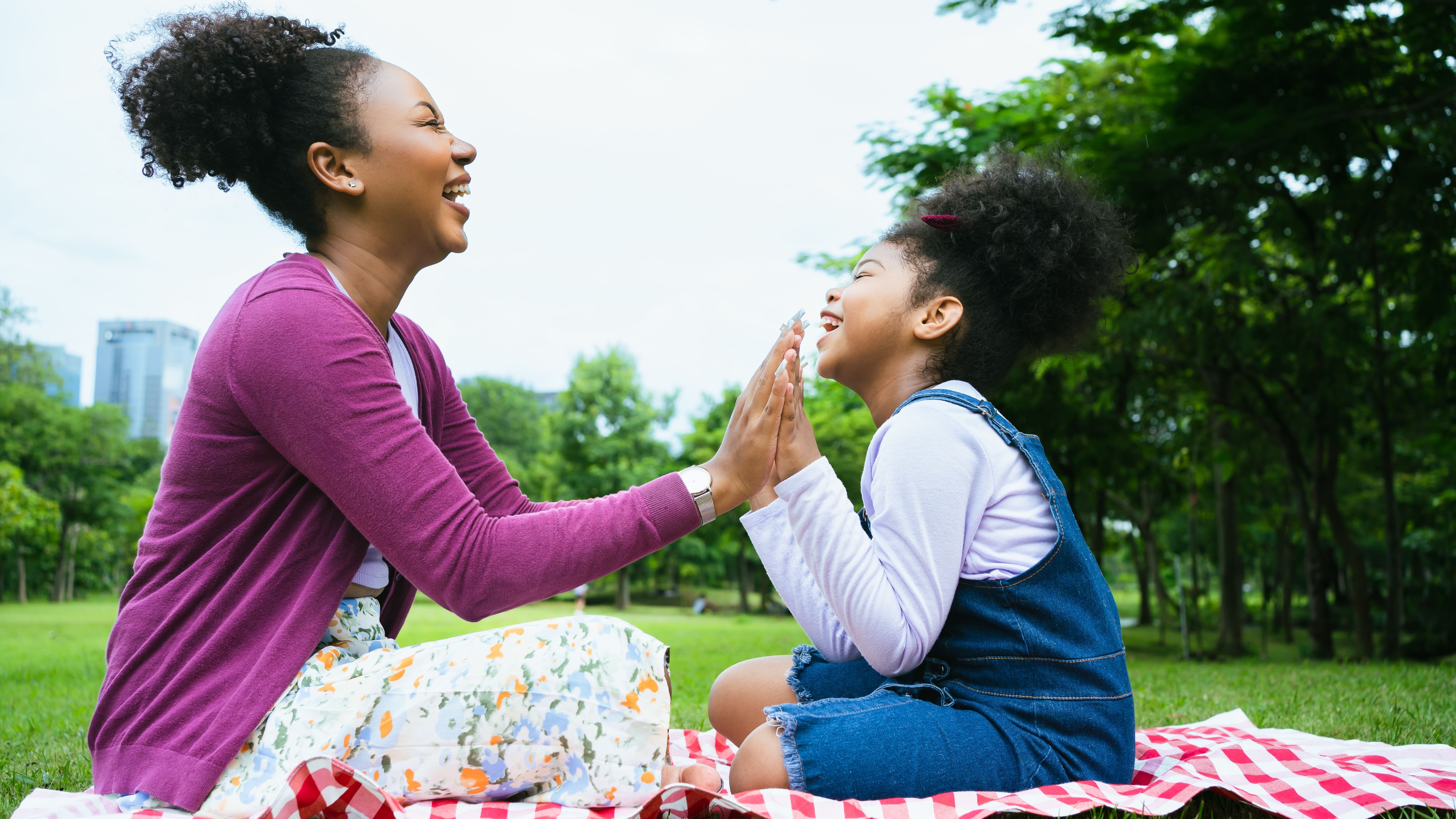 Picnic - mother and daughter facing each other and smiling